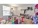 Playroom with hardwood floors, shoe rack, shelving, and a bright window for natural light at 3792 S Pitkin Ct, Aurora, CO 80013
