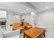 Finished basement with three chairs, a wooden table, and a staircase at 8768 E 54Th Pl, Denver, CO 80238