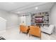 Basement rec room with built-in shelves, modern seating, and a sliding barn door at 8768 E 54Th Pl, Denver, CO 80238