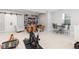 Basement with exercise equipment, chairs, a table, and a tv at 8768 E 54Th Pl, Denver, CO 80238