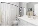 Bathroom with white tile, a shower-tub, and a white vanity at 8768 E 54Th Pl, Denver, CO 80238
