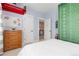 Bedroom with sports decor, a dresser, and an open doorway to the hall at 8768 E 54Th Pl, Denver, CO 80238