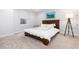 Neutral bedroom featuring carpet, white walls, and a wooden framed bed with simple decor for a cozy and serene setting at 8768 E 54Th Pl, Denver, CO 80238