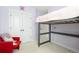 Bedroom featuring a loft bed, carpeted floors, a red chair, and white trim at 8768 E 54Th Pl, Denver, CO 80238