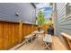 Outdoor wooden deck with bench seating, a dining table and grill perfect for entertaining in the backyard at 8768 E 54Th Pl, Denver, CO 80238