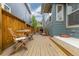 Cozy wooden deck with outdoor seating, perfect for relaxation and entertaining in a private backyard setting at 8768 E 54Th Pl, Denver, CO 80238