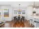 Bright dining room with hardwood floors and views of the kitchen at 8768 E 54Th Pl, Denver, CO 80238
