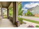 Inviting covered porch featuring brick columns and plenty of space for outdoor seating at 8768 E 54Th Pl, Denver, CO 80238