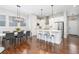 Bright kitchen featuring white cabinets, stainless steel appliances and a modern island with seating at 8768 E 54Th Pl, Denver, CO 80238