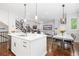 Open kitchen with stainless steel appliances flowing into the dining and living areas at 8768 E 54Th Pl, Denver, CO 80238