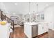 Open-concept kitchen with white cabinets, stainless steel appliances, and a center island at 8768 E 54Th Pl, Denver, CO 80238