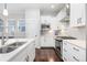 Stylish modern kitchen featuring stainless appliances, white cabinets, and sleek countertops at 8768 E 54Th Pl, Denver, CO 80238