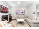 Comfortable living room with fireplace, large screen TV and ceiling fan at 8768 E 54Th Pl, Denver, CO 80238