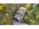 Aerial view of a sprawling residence with a landscaped yard nestled among mature trees at 9001 Eastridge Rd, Golden, CO 80403