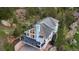 Aerial view of a stunning home surrounded by lush greenery, rocky landscape, and a private deck at 9001 Eastridge Rd, Golden, CO 80403