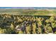 Aerial shot of a luxury estate surrounded by lush, mature trees and expansive green space at 9001 Eastridge Rd, Golden, CO 80403