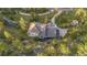 Beautiful aerial shot of a home surrounded by lush greenery and a winding driveway at 9001 Eastridge Rd, Golden, CO 80403