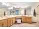 Bright bathroom featuring dual sinks, vanity area, decorative mirror, and a glass-enclosed shower at 9001 Eastridge Rd, Golden, CO 80403