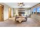 Primary bedroom with carpet floors, ceiling fan, and views of the mountains through the windows at 9001 Eastridge Rd, Golden, CO 80403