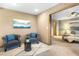 Sitting area adjacent to bedroom with carpet floors, ceiling fan, and neutral walls at 9001 Eastridge Rd, Golden, CO 80403