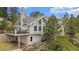 Mountain home exterior featuring a deck, ample windows, and natural rock landscaping at 9001 Eastridge Rd, Golden, CO 80403