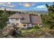 Rear exterior view of mountain home with large windows showcasing the scenic vista at 9001 Eastridge Rd, Golden, CO 80403