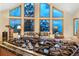 Gas stove cooktop with modern knobs in kitchen with vaulted ceilings and large windows overlooking mountain view at 9001 Eastridge Rd, Golden, CO 80403