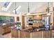 Kitchen island boasts marble countertops, stainless steel appliances, gas stove top and wooden cabinets at 9001 Eastridge Rd, Golden, CO 80403