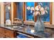 Close up of kitchen sink with black marble countertops and stainless steel faucet under a wooden window trim at 9001 Eastridge Rd, Golden, CO 80403