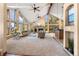 Spacious living room boasting large windows, stone fireplace, and modern furnishings at 9001 Eastridge Rd, Golden, CO 80403