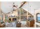 Living room with cathedral ceilings, gas fireplace, large windows, and access to kitchen at 9001 Eastridge Rd, Golden, CO 80403
