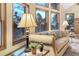 Cozy living room with a view and plush sofa illuminated by a table lamp at 9001 Eastridge Rd, Golden, CO 80403