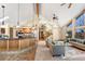 Open concept kitchen and living room with cathedral ceilings, wood floors, and stairway at 9001 Eastridge Rd, Golden, CO 80403