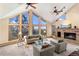 Inviting living room with fireplace, picture windows, and comfortable seating arrangements at 9001 Eastridge Rd, Golden, CO 80403