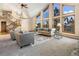 Bright living room with soaring ceilings, large windows, and elegant staircase at 9001 Eastridge Rd, Golden, CO 80403