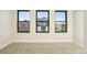 Bright bedroom featuring neutral walls, plush carpeting, and large windows offering ample natural light at 1559 N Hooker St, Denver, CO 80204