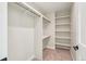 Walk-in closet featuring custom shelving, carpeted floors and ample storage for organizing wardrobes at 1559 N Hooker St, Denver, CO 80204