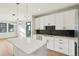 Modern kitchen featuring a large island, stainless steel appliances, white cabinets, and hardwood flooring at 1559 N Hooker St, Denver, CO 80204