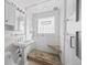 Bathroom featuring shower with glass door and white tile at 536 Detroit St, Denver, CO 80206