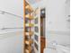 Hallway closet with shelving and wooden drawers in an updated bathroom at 536 Detroit St, Denver, CO 80206