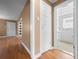 Hallway leading to bathroom with glass shower and white tile at 536 Detroit St, Denver, CO 80206