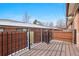 Exterior view of wooden deck with black metal railing and snow-covered ground at 536 Detroit St, Denver, CO 80206