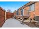 Exterior view of deck with spiral stairs and snow-covered ground at 536 Detroit St, Denver, CO 80206