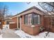 A brick home exterior is enhanced by a corner window allowing natural light to flood the interior at 536 Detroit St, Denver, CO 80206