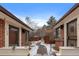 Charming red brick house with walkway, planters, and well-kept landscaping with a backdrop of blue sky at 536 Detroit St, Denver, CO 80206