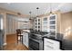 Open kitchen featuring a gas range cooktop, black countertops and stainless oven at 536 Detroit St, Denver, CO 80206