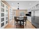 Modern kitchen featuring a kitchen island with bar stools and a stainless steel refrigerator at 536 Detroit St, Denver, CO 80206