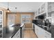 Bright kitchen featuring a gas range cooktop, black countertops and tile floors at 536 Detroit St, Denver, CO 80206