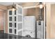 Laundry closet with washer and dryer, with a view of the kitchen at 536 Detroit St, Denver, CO 80206