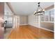 Spacious living room with hardwood floors, built-in shelving, and a chandelier for a modern touch at 536 Detroit St, Denver, CO 80206